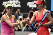 FILE - In this Jan. 27, 2015, file photo, Maria Sharapova, of Russia right, is congratulated by Eugenie Bouchard, of Canada, after winning their quarterfinal match at the Australian Open tennis championship in Melbourne, Australia. If Bouchard had her way, Sharapova would have been banned from tennis for life. The 2014 Wimbledon finalist from Canada, who has been ranked as high as fifth in the world, called Sharapova a cheater upon the Russian's return from a 15-month doping suspension for using the banned substance meldonium. (AP Photo/Andy Brownbill, File)