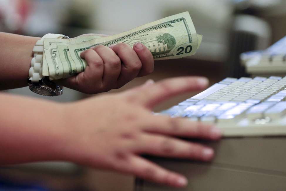 FILE - In this Friday, Nov. 23, 2012, file photo, a cashier rings up a cash sale at a Sears store, in Las Vegas. According to information released Tuesday, April 25, 2017, by the Conference Board, a business research group, U.S. consumer confidence slipped in April but remains at high levels. (AP Photo/Julie Jacobson, File)