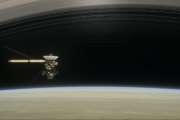 This image made available by NASA in April 2017 shows a still from the short film "Cassini's Grand Finale," with the spacecraft diving between Saturn and the planet's innermost ring. Launched in 1997, Cassini reached Saturn in 2004 and has been exploring it from orbit ever since. Cassini’s fuel tank is almost empty, so NASA has opted for a risky, but science-rich grand finale. (NASA/JPL-Caltech via AP)