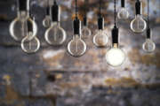 Idea and leadership concept Vintage  bulbs on wall background,  copy space for text