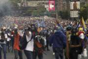 Thousands of opponents of President Nicolas Maduro march in Caracas, Venezuela, Wednesday, April 26, 2017. Security forces blocked anti-government protesters that attempted to march to the Ombudsman's office in downtown in another day of protests that have already claimed dozens of lives since the start of April. (AP Photo/Fernando Llano)