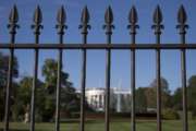 In this photo taken sept. 22, 2014, the iron perimeter fence lines the South Lawn of the White House in Washington. Two Secret Service officers who were on duty the night a man jumped the White House fence and spent more than 15 minutes roaming the grounds have been told the agency intends to fire them.  (AP Photo/Carolyn Kaster)