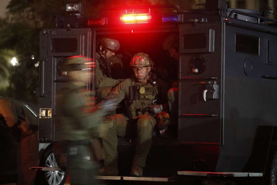 ATF agents board a truck to conduct a raid early Wednesday morning, May 17, 2017, in Los Angeles Twenty-one members and associates of MS-13 were arrested Wednesday morning as hundreds of federal and local law enforcement fanned out across Los Angeles, serving arrest and search warrants. (AP Photo/Jae C. Hong)