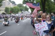 Supporters line the street as motorcyclists participate in the 30th anniversary of the Rolling Thunder 'Ride for Freedom' demonstration in Washington, Sunday, May 28, 2017. Rolling Thunder seeks to bring full accountability for all U.S. prisoners of war and missing in action (POW/MIA) soldiers. (AP Photo/Cliff Owen)