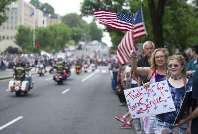 Supporters line the street as motorcyclists participate in the 30th anniversary of the Rolling Thunder 'Ride for Freedom' demonstration in Washington, Sunday, May 28, 2017. Rolling Thunder seeks to bring full accountability for all U.S. prisoners of war and missing in action (POW/MIA) soldiers. (AP Photo/Cliff Owen)