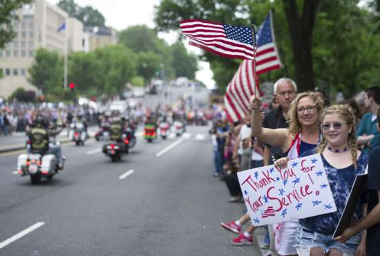 Supporters line the street as motorcyclists participate in the 30th anniversary of the Rolling Thunder 'Ride for Freedom' demonstration in Washington, Sunday, May 28, 2017. Rolling Thunder seeks to bring full accountability for all U.S. prisoners of war and missing in action (POW/MIA) soldiers. (AP Photo/Cliff Owen)