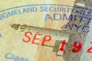 Extreme closeup of a Department of Homeland Security stamp in a Passport.