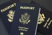 In this May 9, 2017 photo, U.S. passports lie on a table in Dallas, Texas. The U.S. State Department is in the middle of a record year for processing passport applications, with 20.5 million renewals and applications for new passports expected. Adult U.S. passports must be renewed every 10 years, and the 2017 surge comes a decade after a law went into effect requiring passports for U.S. citizens traveling to Mexico, Canada and the Caribbean. (AP Photo/Benny Snyder)