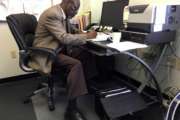 In this May 18, 2017, photo, Nathan Singletary, 67, a social worker for 40 years, fills out paperwork at the AARP Foundation in Harrisburg, Pa. Singletary is beyond the traditional retirement age, but he’s only just beginning a new career - helping other low-income, unemployed Americans over age 55 find jobs. Singletary got his job through the half-century-old Senior Community Service Employment Program, a training and placement program underwritten by taxpayers aimed at putting older Americans back into the workforce. (AP Photo/Laurie Kellman)