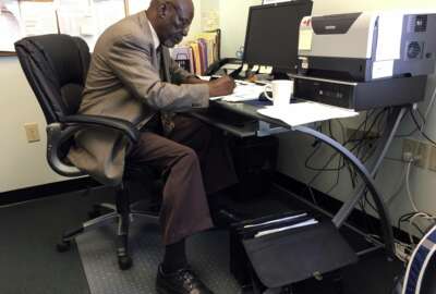 In this May 18, 2017, photo, Nathan Singletary, 67, a social worker for 40 years, fills out paperwork at the AARP Foundation in Harrisburg, Pa. Singletary is beyond the traditional retirement age, but he’s only just beginning a new career - helping other low-income, unemployed Americans over age 55 find jobs. Singletary got his job through the half-century-old Senior Community Service Employment Program, a training and placement program underwritten by taxpayers aimed at putting older Americans back into the workforce. (AP Photo/Laurie Kellman)