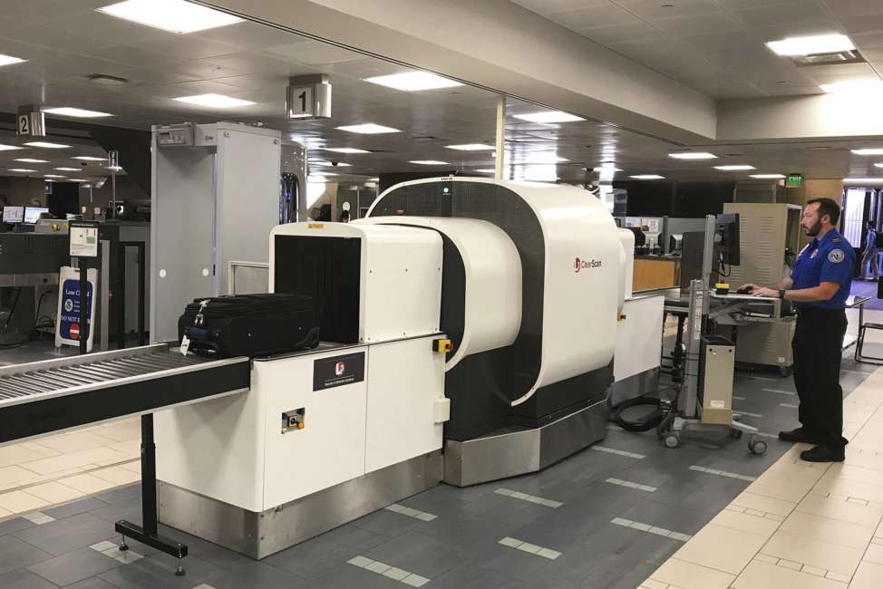 In this Wednesday, June 14, 2017, photo provided by American Airlines, a Transportation Security Administration officer operates an L3 ClearScan baggage screener, featuring 3-D scanning technology, at a checkpoint at Phoenix Sky Harbor International Airport, in Phoenix. The TSA says the technology improves the ability to find bombs. (Ross Feinstein/American Airlines via AP)