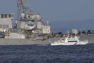 In this Saturday, June 17, 2017, file photo, a Japan Coast Guard ship, foreground, navigates the damaged USS Fitzgerald near the U.S. Naval base in Yokosuka, southwest of Tokyo, after the U.S. destroyer collided with the Philippine-registered container ship ACX Crystal in the waters off the Izu Peninsula. The USS Fitzgerald was back at its home port in Japan after colliding before dawn Saturday with a container ship four times its size, while the coast guard and Japanese and U.S. military searched for seven sailors missing after the crash. (AP Photo/Eugene Hoshiko, File)