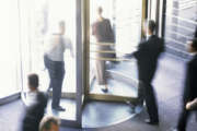 High angle view of business executives walking through a revolving door