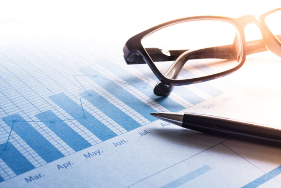 Pen and glasses on business graph chart.Business financial,investment