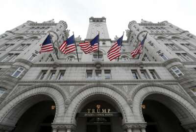 FILE - In this Dec. 21, 2016, file photo, the Trump International Hotel on Pennsylvania Avenue in Washington. First lady Melania Trump is appointing the director of rooms at the Trump Organization's Washington hotel to be the new White House chief usher. It's the latest example of the remarkable co-mingling between President Donald Trump's White House and his business world. Timothy Harleth will oversee the White House residence staff, more than 90 people in all.(AP Photo/Alex Brandon, File)