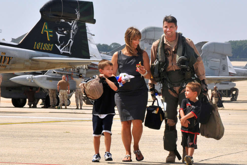 U.S. Navy Cmdr. Michael Esper, assigned to Tactical Electronics Warfare Squadron (VAQ) 209, walks across the flight line with his wife and children during a homecoming celebration at Joint Base Andrews Naval Air Facility Washington in Maryland Sept. 7, 2010. VAQ-209 is returning to the states following a three-month, forward-deployed tour to Afghanistan supporting Operation Enduring Freedom. (DoD photo by Mass Communication Specialist 2nd Class Clifford H. Davis/Released)