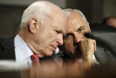 Senate Armed Services Committee Chairman Sen. John McCain, R-Ariz., left, talks to the committee's ranking member Sen. Jack Reed, D-R.I. on Capitol Hill in Washington, Tuesday, July 11, 2017, during the committee's confirmation hearing for Navy Secretary nominee Richard Spencer.  (AP Photo/Jacquelyn Martin)