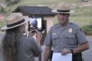 In a Sunday, July 16, 2017 photo, Justin Cawiezel, chief ranger at the Scotts Bluff National Monument, listens to questions from students in Afghanistan while Park Ranger Lesley Gaunt, lead interpreter, makes sure students and Cawiezel can see and hear each other. Park Superintendent Dan Morford, lead interpreter Lesley Gaunt and Chief Ranger Justin Cawiezel were at the Scotts Bluff National Monument on Sunday to give more than 60 Afghan students a virtual tour through an iPad. (Irene North/The Star-Herald via AP)