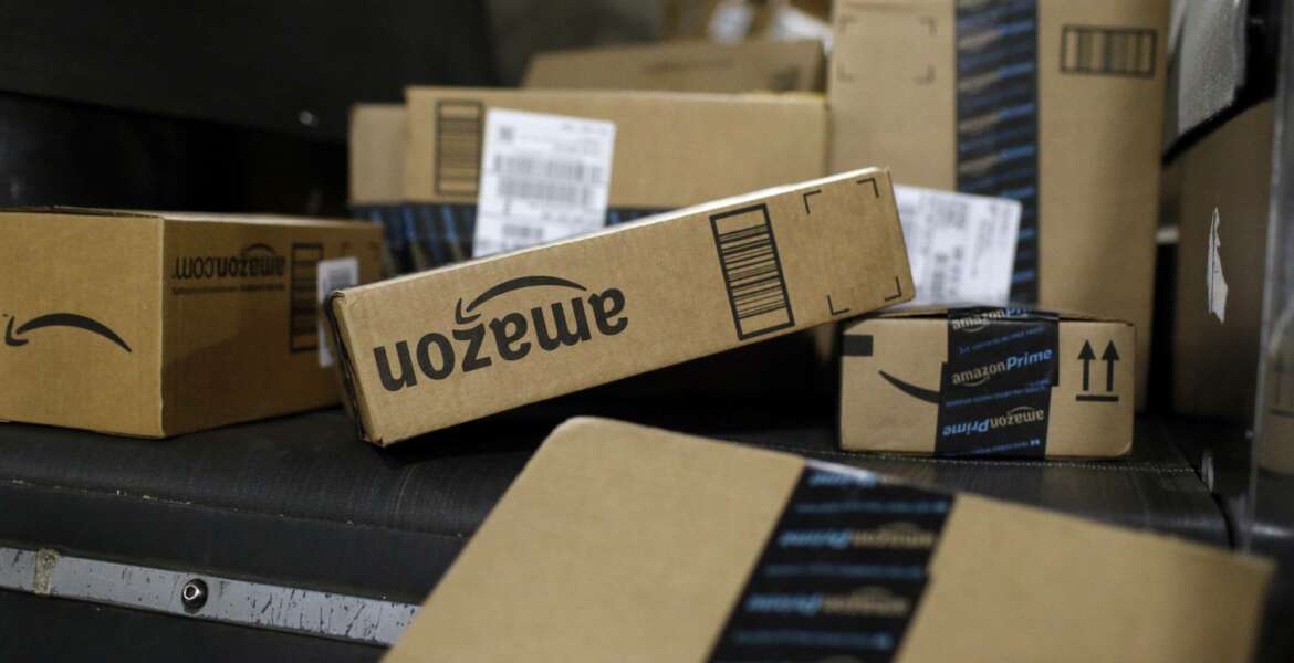 In this Nov. 20, 2015, photo, packages being shipped in Amazon boxes ride a conveyor belt at the UPS Worldport hub in Louisville, Ky. Amazon is already a huge part of many people’s lives. And its $13.7 billion deal for the organic grocer Whole Foods will likely bind its customers even more tightly. While Amazon is the clear leader in e-commerce, 90 percent of worldwide retail spending is still in brick-and-mortar stores, according to eMarketer. (AP Photo/Patrick Semansky)