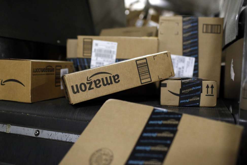 In this Nov. 20, 2015, photo, packages being shipped in Amazon boxes ride a conveyor belt at the UPS Worldport hub in Louisville, Ky. Amazon is already a huge part of many people’s lives. And its $13.7 billion deal for the organic grocer Whole Foods will likely bind its customers even more tightly. While Amazon is the clear leader in e-commerce, 90 percent of worldwide retail spending is still in brick-and-mortar stores, according to eMarketer. (AP Photo/Patrick Semansky)