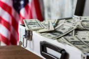 Pile of dollars in suitcase. USA flag, cash and case. More chances for victory. Compliment from local executive.