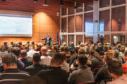 Business speaker giving a talk in conference hall.