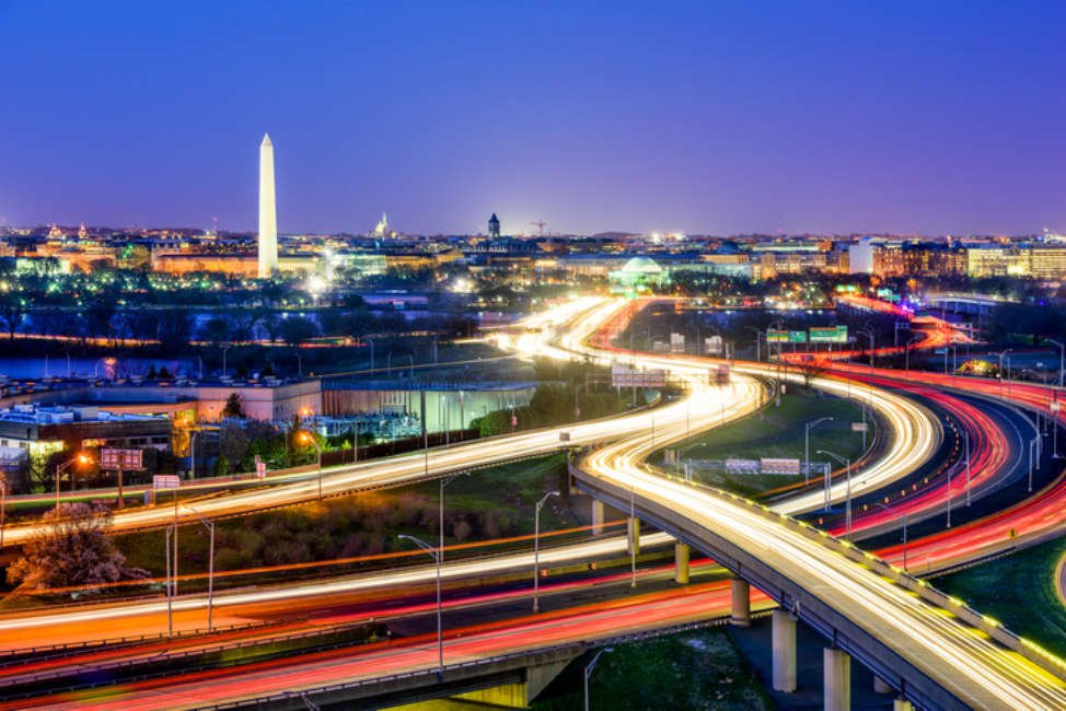 Washington, D.C. skyline with highways and monuments.