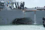 Damage to the portside is visible as the Guided-missile destroyer USS John S. McCain (DDG 56) steers towards Changi naval base in Singapore following a collision with the merchant vessel Alnic MC Monday, Aug. 21, 2017. The USS John S. McCain was docked at Singapore's naval base with "significant damage" to its hull after an early morning collision with the Alnic MC as vessels from several nations searched Monday for missing U.S. sailors. (Mass Communication Specialist 2nd Class Joshua Fulton/U.S. Navy photo via AP)