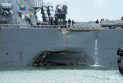 Damage to the portside is visible as the Guided-missile destroyer USS John S. McCain (DDG 56) steers towards Changi naval base in Singapore following a collision with the merchant vessel Alnic MC Monday, Aug. 21, 2017. The USS John S. McCain was docked at Singapore's naval base with 