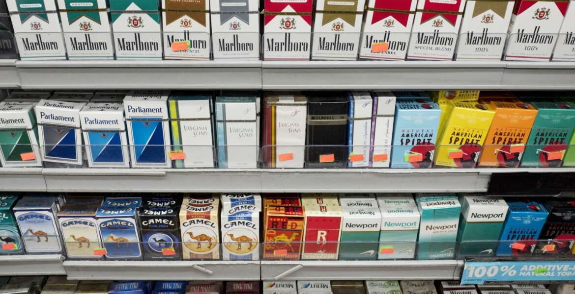 Cigarettes are displayed on a shelf, Monday, Aug. 28, 2017, in New York. Mayor Bill de Blasio is expected to sign legislation raising the legal minimum price for a pack of cigarettes to $13. The hike from $10.50 further cements the city's claim on having among the most expensive cigarettes in the country. (AP Photo/Mark Lennihan)
