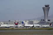 FILE - In this July 11, 2017 file photo, departing and parked aircraft intersect at San Francisco International Airport in San Francisco. Federal officials are imposing new rules on nighttime landings at San Francisco airport after a close call last month. The FAA will also require 2 controllers in the tower. The changes come after an Air Canada jet narrowly missed planes on the ground before aborted an off-line landing on July 7, 2017. (AP Photo/Marcio Jose Sanchez, File)