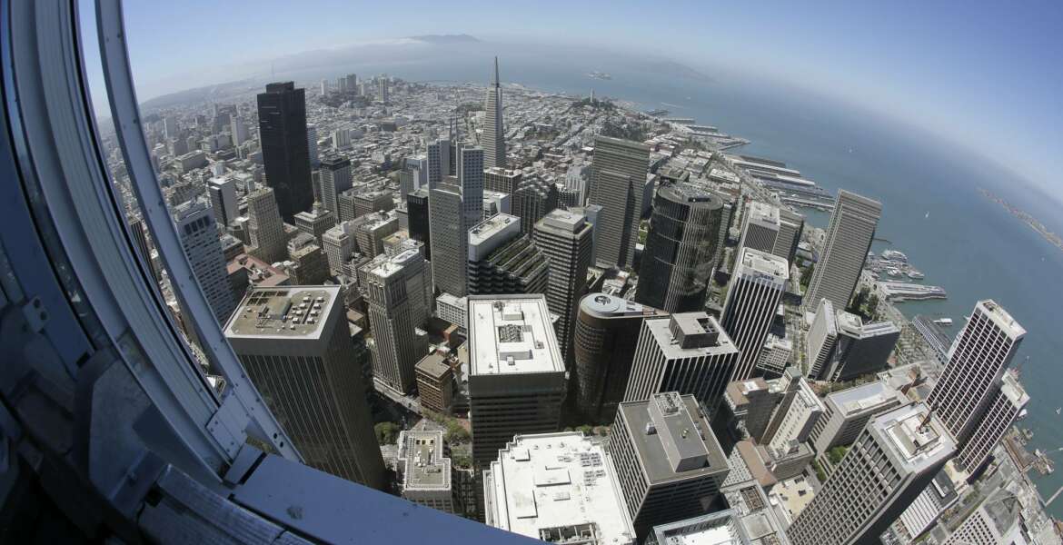 In this photo taken Tuesday, July 11, 2017, the Transamerica Pyramid and Golden Gate Bridge at left are seen below from the top of the Salesforce Tower in San Francisco. Construction crews are putting the finishing touches on San Francisco’s new tallest building. The 61-story Salesforce Tower and an adjacent transit center represent a shift in San Francisco, one that pits the technology industry against the city’s charming neighborhoods. (AP Photo/Eric Risberg)