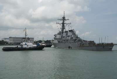 In this Aug. 21, 2017, photo provided by U.S. Navy, tugboats from Singapore assist the Guided-missile destroyer USS John S. McCain (DDG 56) as it steers towards Changi Naval Base, Singapore following a collision with the merchant vessel Alnic MC while underway east of the Straits of Malacca and Singapore. The U.S. Navy ordered a broad investigation into the performance and readiness of the Pacific-based 7th Fleet after the USS John S. McCain collided with an oil tanker in Southeast Asia. (Mass Communication Specialist 2nd Class Joshua Fulton/U.S. Navy via AP)