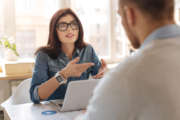 Attractive smart woman explaining something to her colleague