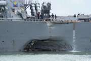 FILE - In this Aug. 21, 2017, file photo, damage is visible as the guided-missile destroyer USS John S. McCain steers towards Changi naval base in Singapore following a collision with the merchant vessel Alnic MC. Adm. William Moran, the vice chief of naval operations, told a congressional oversight panel Sept. 7, that the hectic pace of military operations and a constrained military budget don’t excuse two warship accidents in the Pacific region that killed 17 American sailors and led the sea-going service to order a broad investigation into its performance and readiness.(Mass Communication Specialist 2nd Class Joshua Fulton/U.S. Navy via AP, File)