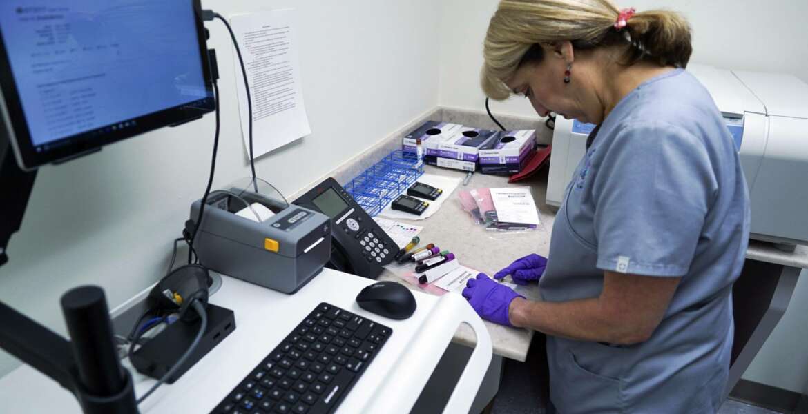 In this Aug. 7, 2017, photo, Stephanie Richurk, a nurse at the University of Pittsburgh Medical Center, sorts blood samples collected from participants in the 