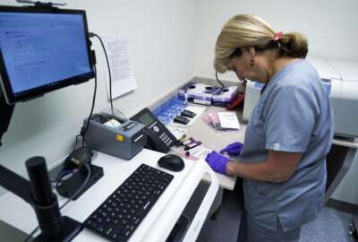 In this Aug. 7, 2017, photo, Stephanie Richurk, a nurse at the University of Pittsburgh Medical Center, sorts blood samples collected from participants in the 