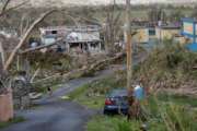 Jonathan Aponte walks with a gas can up the road to his home in the aftermath of Hurricane Maria, in Yabucoa, Puerto Rico, Tuesday, Sept. 26, 2017. Governor Ricardo Rossello and Resident Commissioner Jennifer Gonzalez, the island’s representative in Congress, have said they intend to seek more than a billion in federal assistance and they have praised the response to the disaster by President Donald Trump, who plans to visit Puerto Rico next week, as well as FEMA Administrator Brock Long.  (AP Photo/Gerald Herbert)