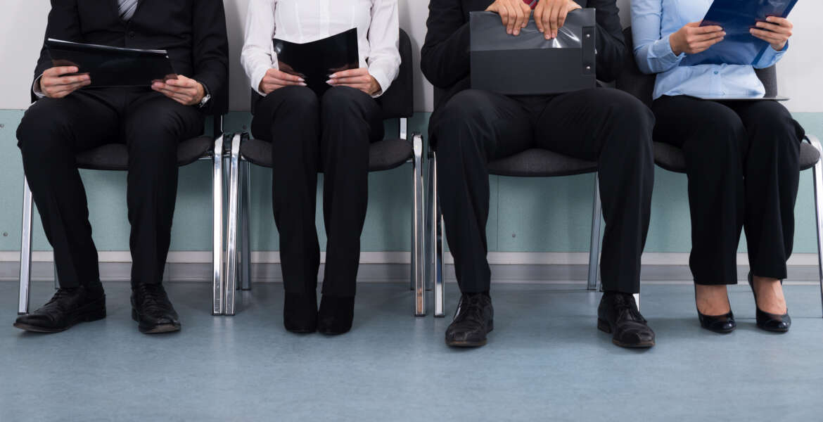 Close-up Of Businesspeople With Files Sitting On Chair
