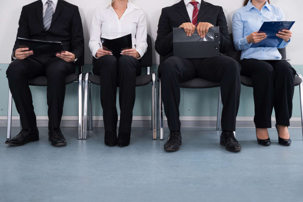 Close-up Of Businesspeople With Files Sitting On Chair