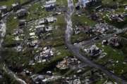 FILE - In this Sept. 28, 2017, file photo, debris scatters a destroyed community in the aftermath of Hurricane Maria in Toa Alta, Puerto Rico. The Senate is pushing ahead on a $36.5 billion hurricane relief package that would give Puerto Rico a much-needed infusion of cash but rejects requests from the powerful Texas and Florida congressional delegations for additional money to rebuild after hurricanes Harvey and Irma. The measure is sure to sail through a Monday, Oct. 23, procedural vote and a final vote is expected no later than Tuesday. (AP Photo/Gerald Herbert, File)