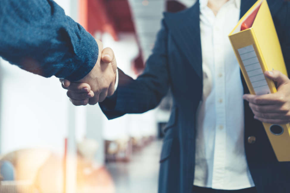 Business people shaking hands. Two managers after successful partnership