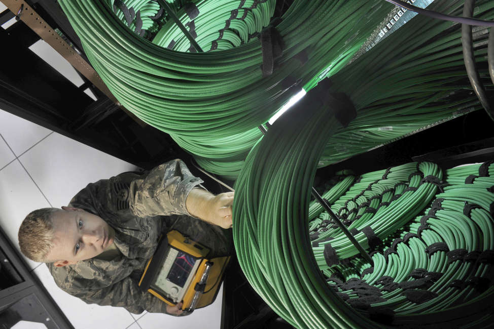 Tech. Sgt. Wyatt Bloom uses a spectrum analyzer to check television broadcast network routers at the Defense Media Activity’s Headquarters at Fort Meade, Md., July 18, 2012. Bloom is a cyber-transport technician assigned to DMA. (U.S. Air Force photo by Val Gempis)