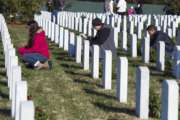 Volunteers place wreaths at headstones in Arlington National Cemetery as Wreaths Across America places remembrance wreaths on the nearly 245,000 headstones at the cemetery in Arlington, Va., Saturday, Dec. 16, 2017. (AP Photo/Cliff Owen)