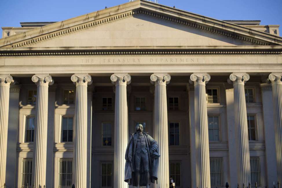 FILE - This Thursday, June 8, 2017, file photo shows the U.S. Treasury Department building in Washington. The federal government collected a record amount of tax income for the month of November 2017 and also had a record level of spending for the month, producing a budget deficit of $138.5 billion, up slightly from a year earlier. (AP Photo/Pablo Martinez Monsivais, File)