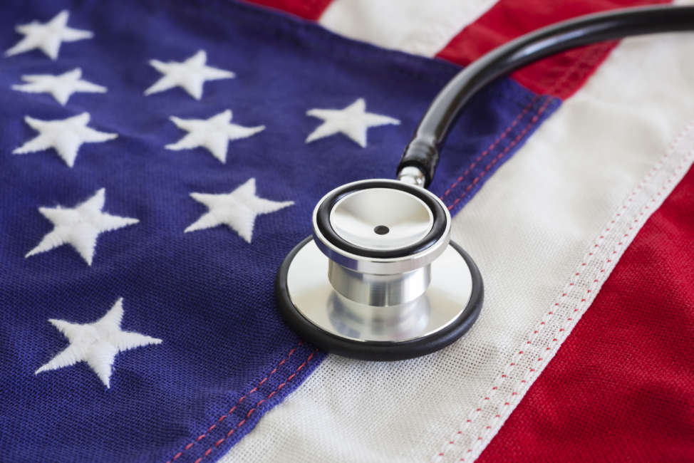 Healthcare reform concept with stethoscope and USA flag.