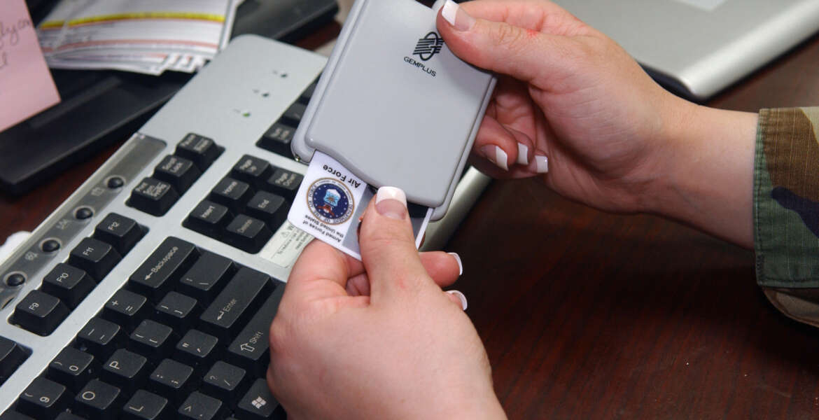 U.S. Air Force Senior Airman Tabitha Gracie, from the 2nd Communications Squadron's multimedia center, inserts her identification card into the Common Access Card (CAC) reader so that she can update her current password to meet security measures.  The Do D is now making it mandatory to use the CAC reader in order to log into government computer systems.  (U.S. Air Force photo by Airman 1st Class Kendra N. Fulton) (Released)