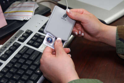 U.S. Air Force Senior Airman Tabitha Gracie, from the 2nd Communications Squadron's multimedia center, inserts her identification card into the Common Access Card (CAC) reader so that she can update her current password to meet security measures.  The Do D is now making it mandatory to use the CAC reader in order to log into government computer systems.  (U.S. Air Force photo by Airman 1st Class Kendra N. Fulton) (Released)