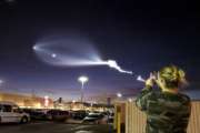 A Hair Salon worker photographs the light display of SpaceX's Falcon 9 rocket launch, Friday, Dec. 22 2017, in Apple Valley, Calif. The launch was more than 200 miles from Apple Valley yet was still brilliantly visible. The Falcon 9 booster lifted off from coastal Vandenberg Air Force Base, carrying the latest batch of satellites for Iridium Communications. (James Quigg/The Daily Press via AP)