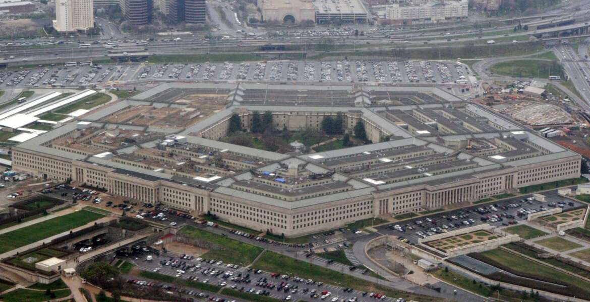 FILE - In this March 27, 2008 file photo, the Pentagon is seen in this aerial view in Washington. A Pentagon official tells The Associated Press that transgender people can enlist in the military beginning Jan. 1, despite President Donald Trump's opposition. The new policy reflects growing legal pressure on the issue. Potential transgender recruits will have to overcome a lengthy and strict set of physical, medical and mental conditions that make it possible, although difficult, for them to join the armed services. (AP Photo/Charles Dharapak, File)